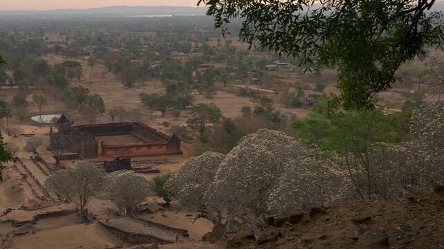 Elevated view from the top of Vat Phou overlooks the North and South Palaces, processional path, baray, and landscape below.