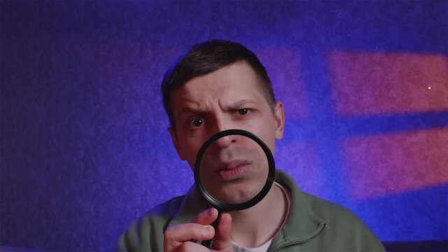 Skeptical man looking at camera with enlarged mouth through lens