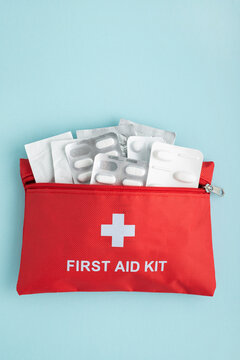 Red first aid kit bag with medicine blister packs