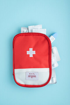 Red first aid kit with medical supplies for health and safety