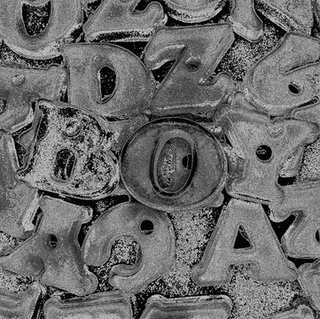 Gritty industrial metal texture background with alphabet letters spelling boy