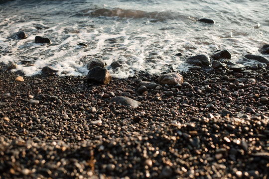 Nature background with sea water and rock stones at coast line. Summer vacation time.