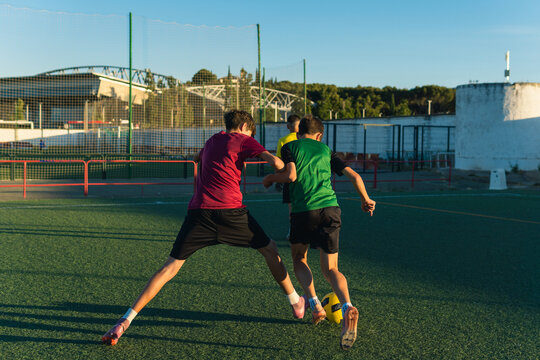 Boys playing soccer practicing on artificial grass field