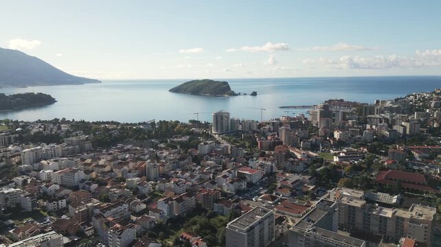 Drone flying forwards to unveils a scenic view of Budva, a coastal Adriatic city located in southern Crna Gora.