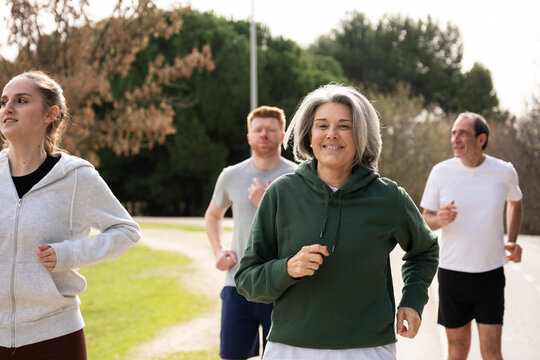 Diverse age group enjoying an outdoor run, promoting active and healthy lifestyles