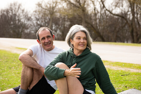 Senior couple stretching outdoors enjoying healthy lifestyle