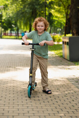 Joyful moments of childhood enjoyed by redhead boy on a sunny day at the park with a scooter © LIGHTFIELD STUDIOS