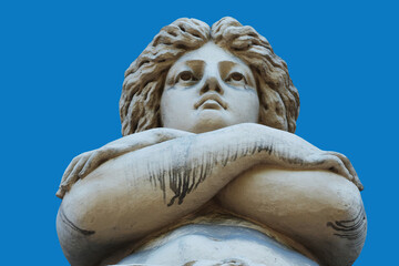 Low-angle view of the ancient marble statue of Aphrodite against a clear blue sky, symbolizing beauty, love, femininity, grace, and classical Greek mythology. © zwiebackesser