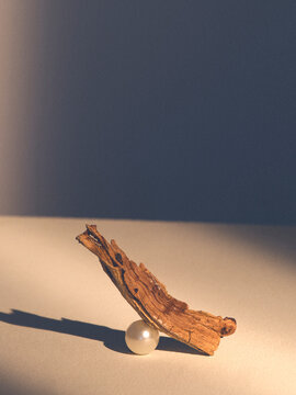 artistic wood piece balancing on a pearl