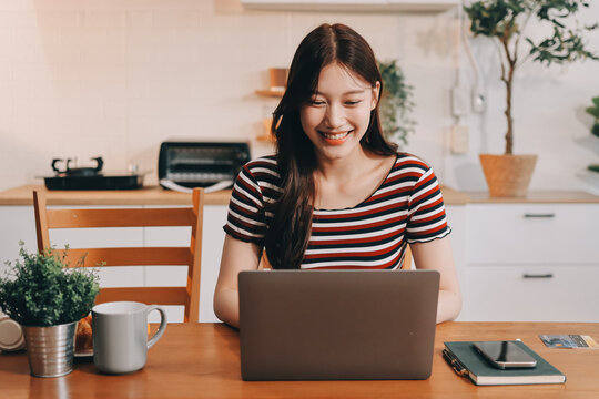 Asian woman using computer remote for business studying, watching online virtual webinar training meeting, video call. asian business woman talking on laptop in home office. Banner, copy space