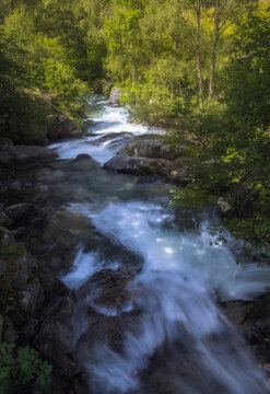 A serene river meanders through a lush valley in Lles, Cerdanya, Catalonia