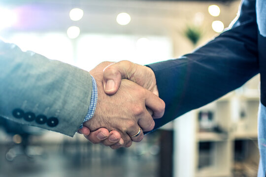 Close-up of corporate professionals sealing a successful business deal with a firm handshake