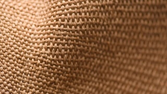 Wicker texture background, close up straw hat weave textile backdrop, top view, natural craft wallpaper. Closeup view of straw woven hand made texture background. Rotating. 
