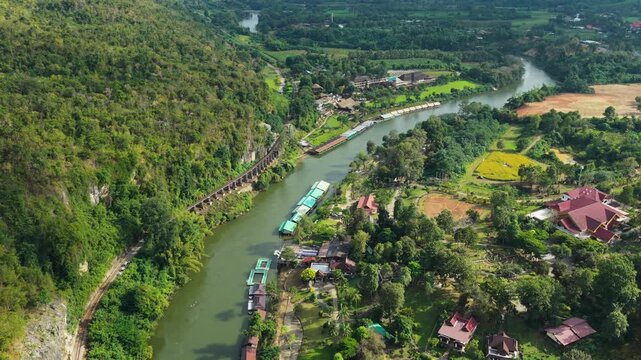 Drone pullback of Krasae River with cliff railway and floating rafts in Kanchanaburi, drone