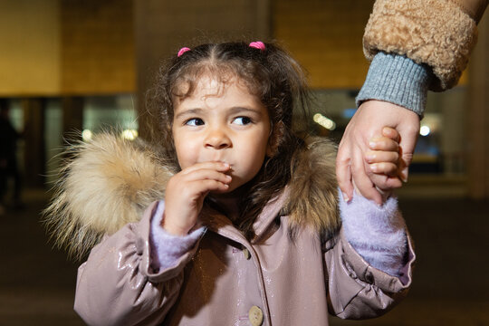 Little girl child holding family hand walking at night