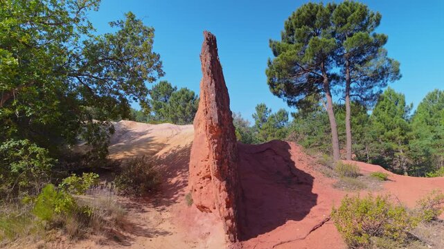 Red sandstone spire in the Colorado Provencal, a spectacular semi-natural landscape of ancient ochre quarries located next to the village of Rustrel , France