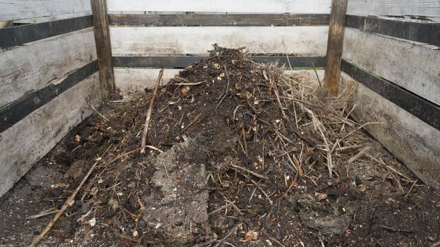 Filling compost bin with material for making homemade vermicompost close-up 