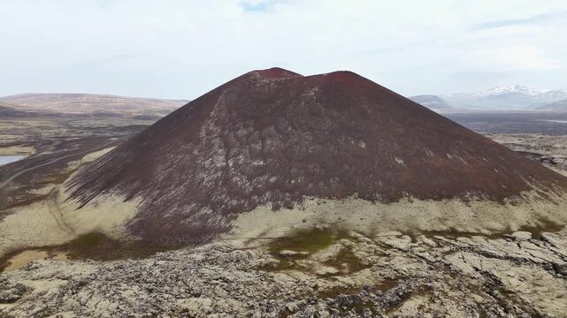 Symmetrical volcanic scoria cone rising from lava field, Snaefellsnes Peninsula, Iceland