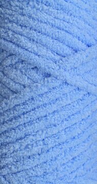Blue fluffy yarn texture seamless loop. Close-up soft chenille fabric with braided fluffy surface, smooth seamless loop motion. Ideal for fashion, cozy and textile backgrounds.