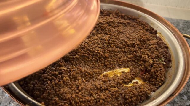 Buffet restaurant serving stewed lentils, warm hearty dish, self-service healthy meal, plant protein.