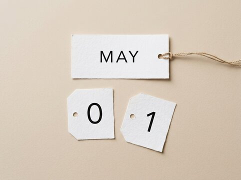 May first calendar tag with torn numbers, representing the start of a new month or event.