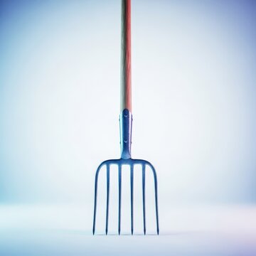 Robust metallic farm tool with multiple sharp tines and a long wooden handle used for moving hay, straw, or manure in agricultural settings, heap, stable, loose material