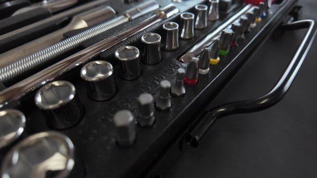 Precision tool set revealed as the camera moves forward, showcasing organized socket and bit layout.