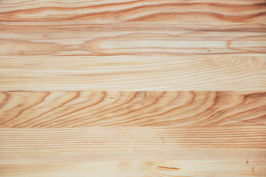 Light natural wood plank texture with visible grain patterns and warm tones. Rustic wooden surface background for design, interiors and creative projects.
