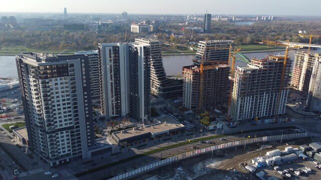 Rotating drone capture unveil a large residential district under development located on the riverbank in Belgrade, Serbia.