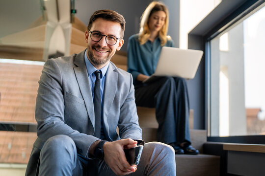 Successful executive standing proudly in office, representing business growth, partnership