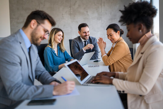 Multicultural business professionals in office, teamwork to achieve corporate success together