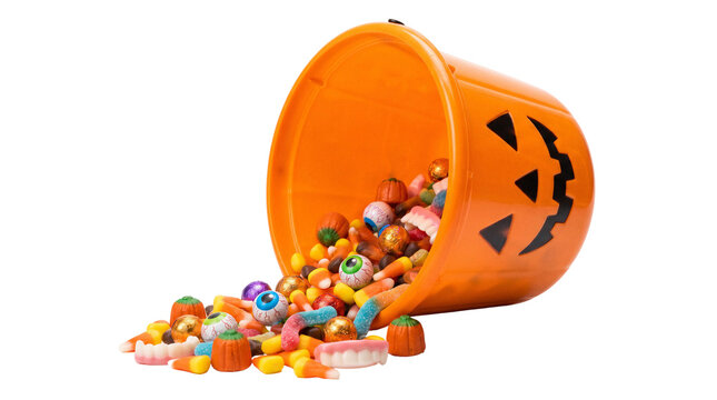 Orange halloween pumpkin bucket spilling colorful candy, gummy worms and eyeball sweets isolated on white or transparent background.