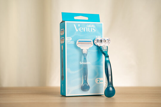 STRASBOURG, FRANCE - JULY 2, 2026 : Blue Gillette Venus women razor and boxed packaging displayed on a wooden table, highlighting shaving, personal care, grooming and smooth skin concepts in a clean