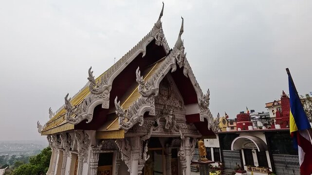 Nagar Mandap Shree Kirti Bihar Thai temple close-up of ornate gold roof facade, naga carvings and Buddhist flag, Kirtipur Nepal