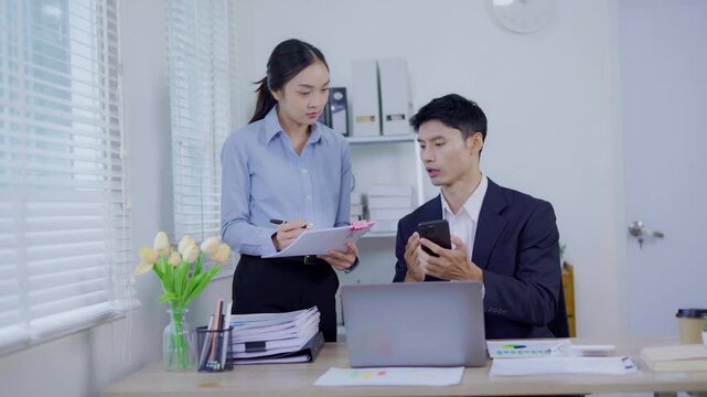 Two Asian businesswomen shaking hands with colleague. Two professional business owners shaking hands to agree to work together in an organization.	
