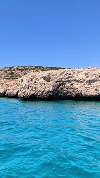 A boat excursion along the rocky Mediterranean coastline of Cyprus with turquoise waters on a sunny summer day. Active recreation, tourism, and sightseeing in Protaras