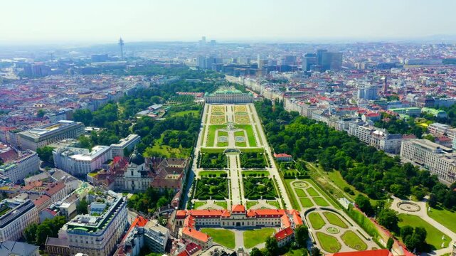 Vienna, Austria. Belvedere Palace, the baroque palace complex with formal French gardens, Drone footage over the historic cityscape under clear summer sky. Drone footage
