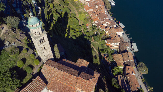 Aerial close up of historic church bell tower and rooftops in Morcote village
