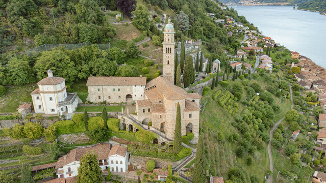 Aerial view of historic church complex with bell tower and cemetery in Morcote
