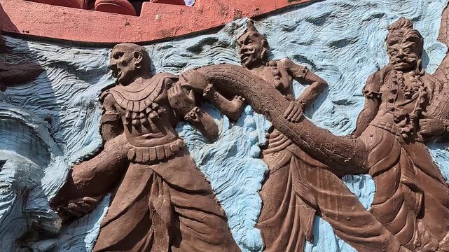 Slide along the Samudra Manthan relief of gods churning the ocean at Gupteshwor Mahadev Cave, Pokhara, Nepal
