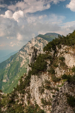 Adventure travel destination featuring rocky cliffs and green mountain slopes o, ideal for nature exploration in Monte Baldo Natural Park, Brentonico,Trentino,Veneto Italy.