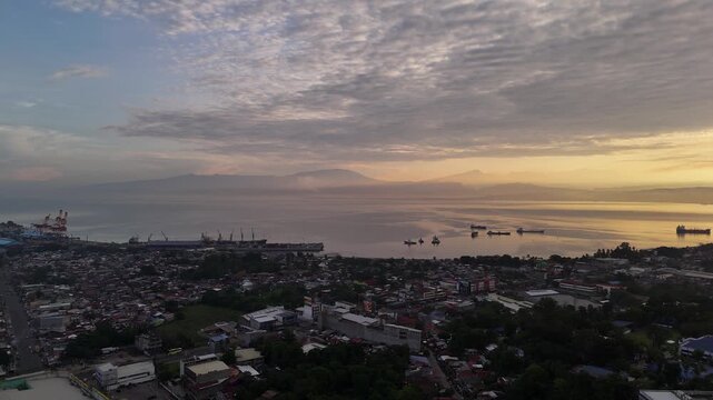 Aerial forward flight over the urban cityscape of Cagayan de Oro moving towards Macajalar Bay, Mindanao, Philippines