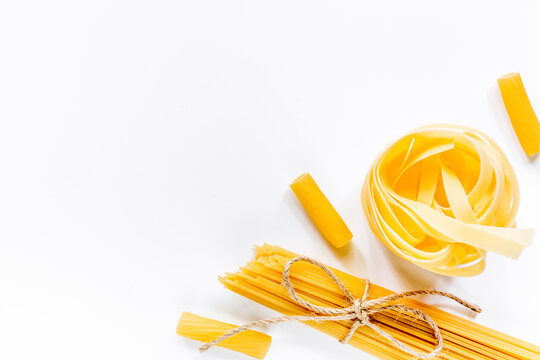 Italian food concept various kind of pasta on white background top view copyspace