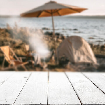 Beach camping scene on a sandy tropical shoreline under a bright blue sky. Copy space for product placement or advertising text with relaxing outdoor summer atmosphere.