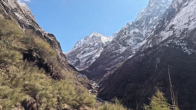 Snow-capped peaks framing the upper Modi Khola valley under blue sky, Annapurna, Nepal