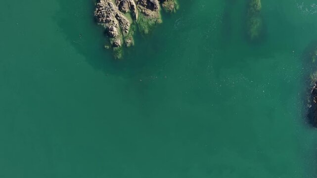 Top down drone reveal moving forward over LLanddwynn lighthouse, Anglesey