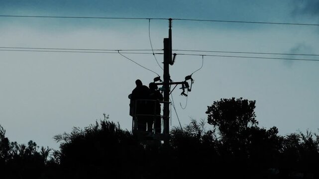 Men working on high power electrical lines