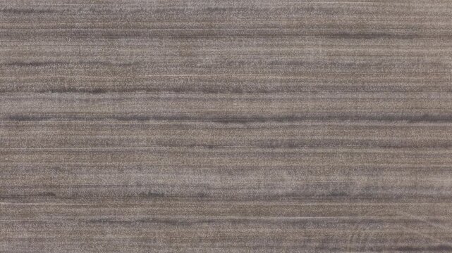 A close-up view of dark, horizontal wood grain texture with natural organic patterns, suitable for interior design backdrops and mockups.