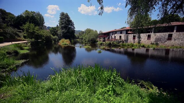 Cascading Waterfall Weir along the Arnoia River and Green Parklands in the Village of Allariz Galicia
