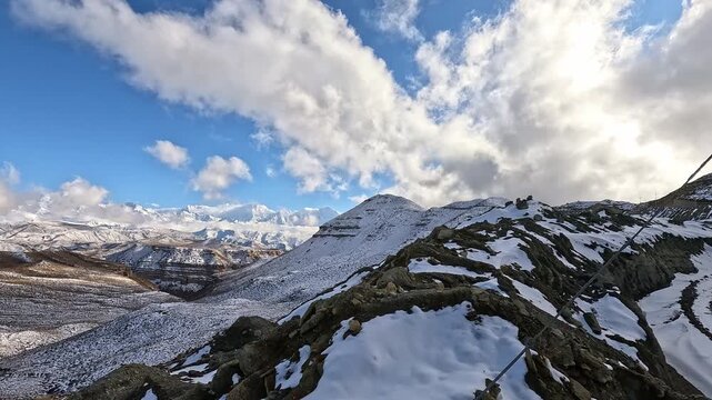 Walking a snowy ridge with Annapurna, Tilicho and Nilgiri peaks beyond, Upper Mustang, Nepal